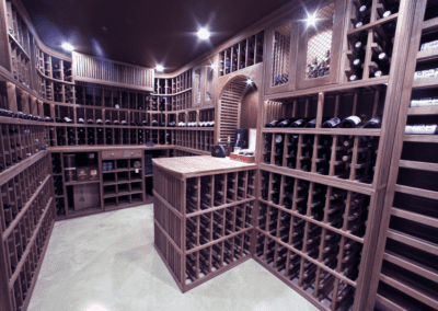 An elegantly designed wine cellar with wooden racks filled with bottles and a central tasting table.